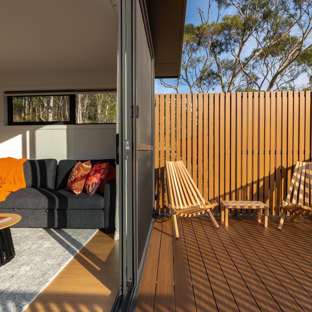 Split screen between living room and deck of ironbark cabin