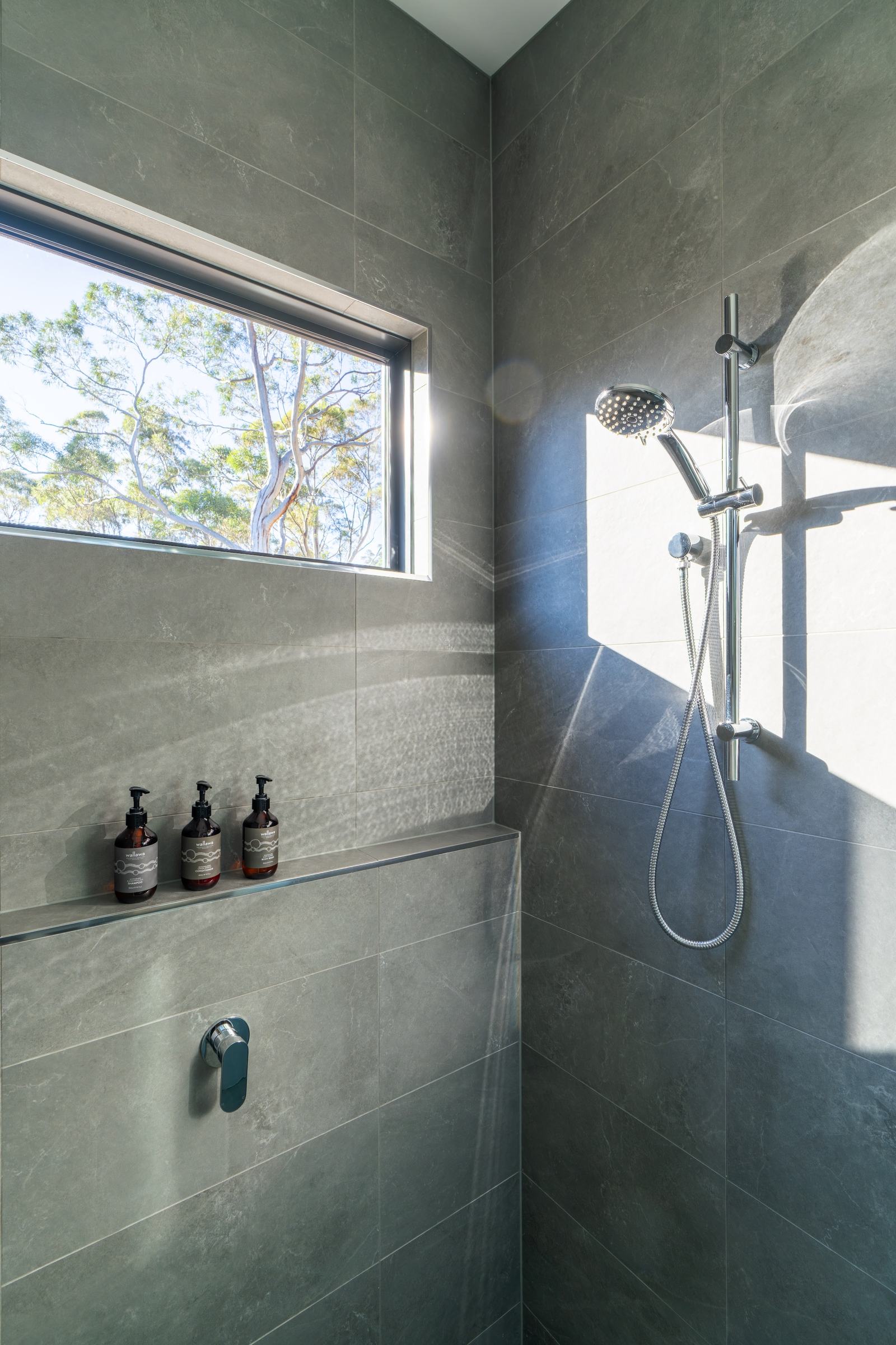 Shower of mosswood cabin with view out to forest