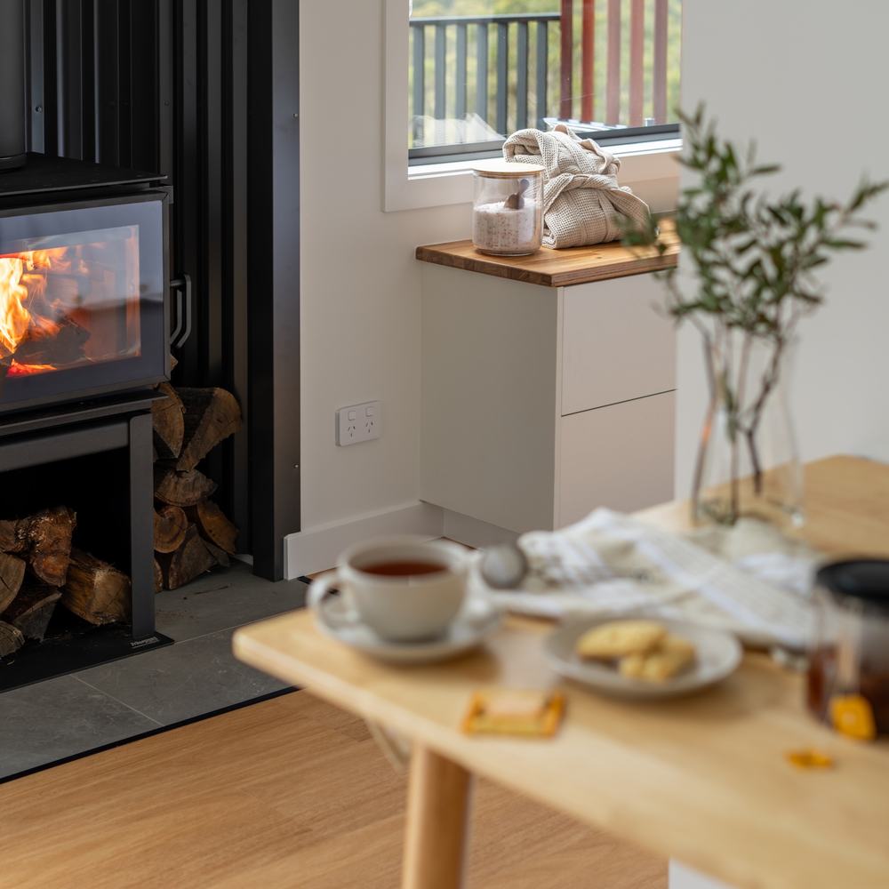 Warm fireplace with tea and biscuits waiting on the table nearby